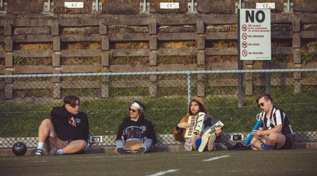 Players playing musical instruments on the sidelines - Sports Zone sunday league