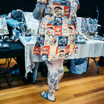 Tattooed woman wearing patchwork dress at Wellington tattoo convention 2021