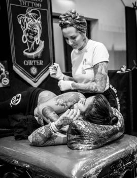 A tattoo artist and client at Wellington tattoo convention 2021 monochrome