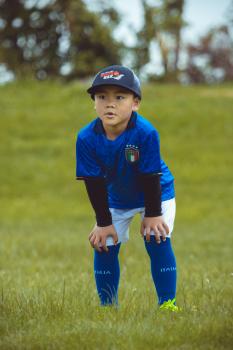 Kid in Italian kit with hands on knees - Little Dribblers