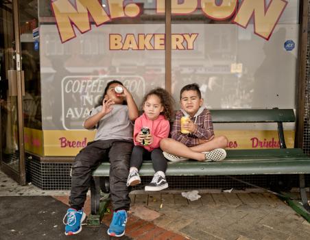 Cute kids on a bench drinking soda at Newtown festival 2021