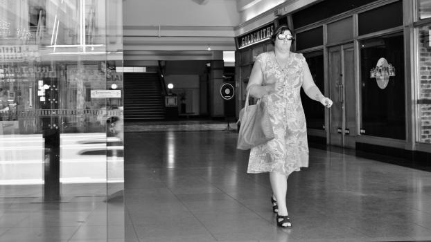 Woman walking out of a mall at K' road monochrome
