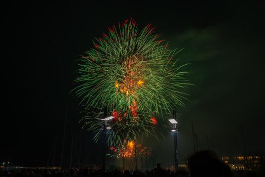 Green and orange fireworks over harbour