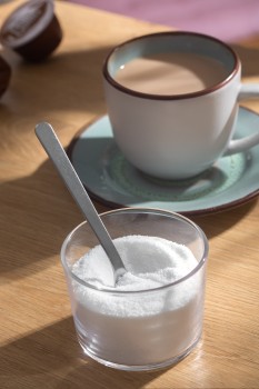 Tea cup and container of stevia on a table