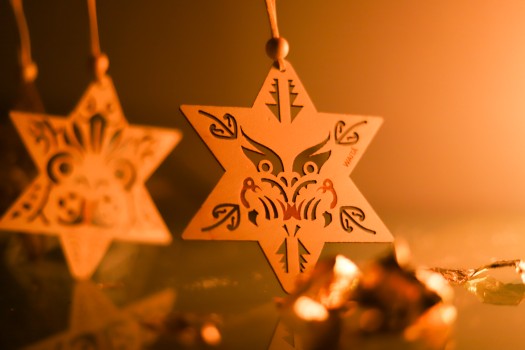 Matariki Waita star wooden ornament on golden background