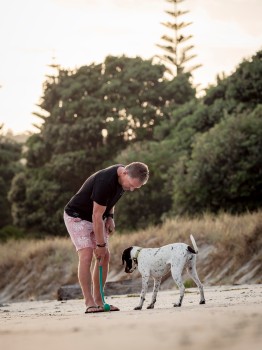 Man Training Dog Beach