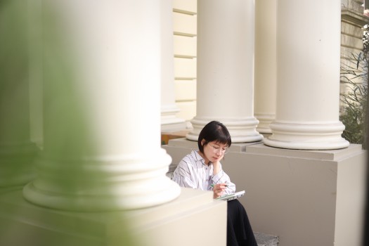 Young lady studying in stairwell
