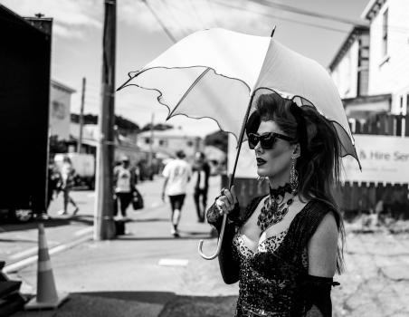 Woman with an umbrella at Newtown Festival 2020 black and white