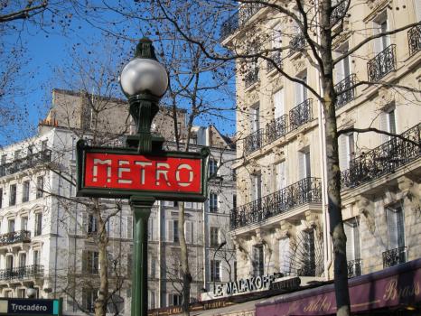 Street light and Paris metro signage in a street