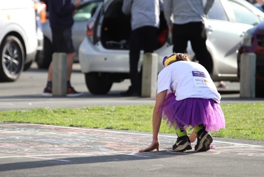 Girl in purple skirt chalking, R4L 2022