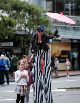 Woman on stilts with kids