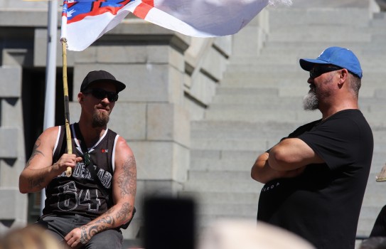 Tattooed guy on stage with flag - Convoy 2022