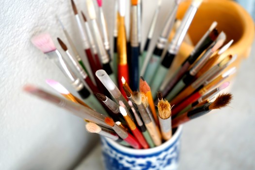 Detail of paint brushes and bright paint
