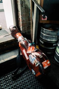 Snake skin textured guitar case wanaka next to beer kegs