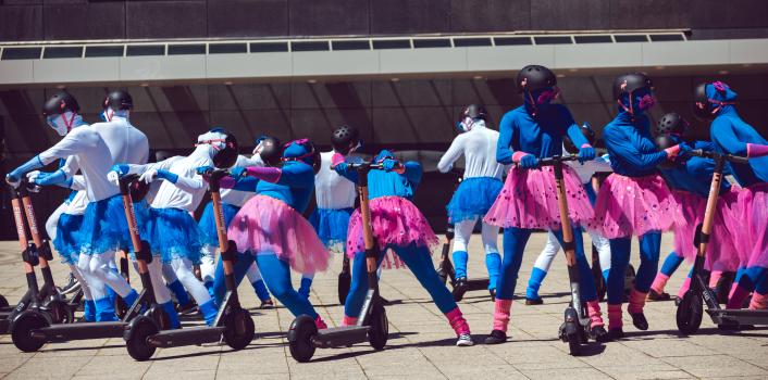Ballet performers in blue white apparel and blue pink skirts