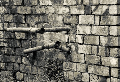 Old pipes ona brick wall