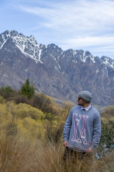 Young man looking back to Remarkables
