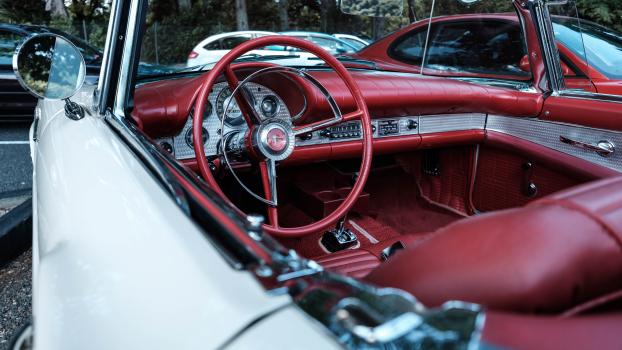 White convertible classic car with red interior