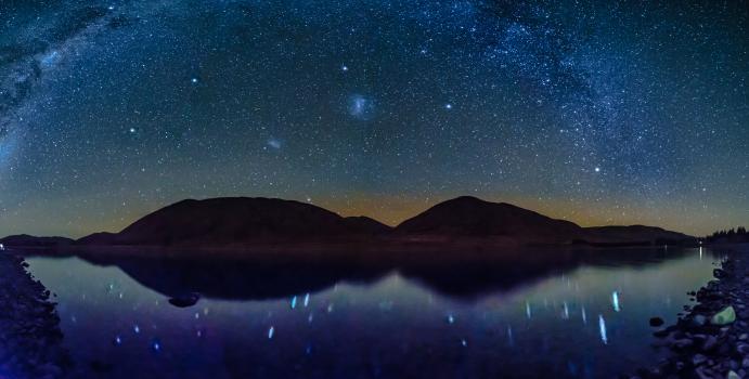 Galaxy of stars over the alpine lake 