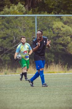 Football player in black shirt clapping - Sports Zone sunday league