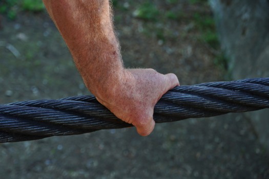 Mans hand on wire rope