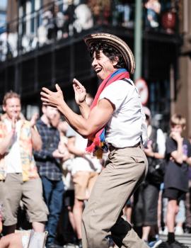 Curly haired muscular man dancing in the street at Cuba Dupa 2021 bokeh