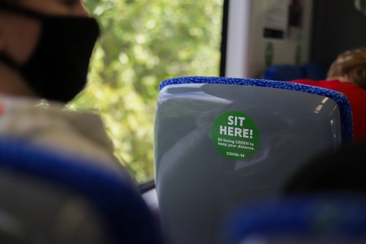 "Sit Here" sign in public transport