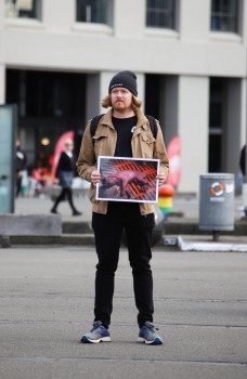 Protester holding picture of a pig, NARD 2022