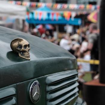 Skull hood ornament on a green Mercedes Benz truck