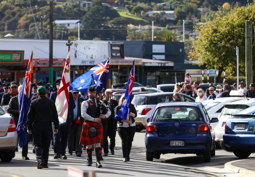 Parade marching under NZ flag at ANZAC 22