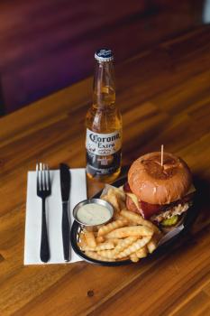 Corona beer, burger and zigzag cut fries