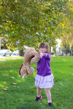 Child with Down syndrome with stuffed toy