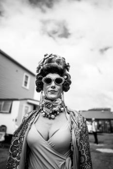 Woman with rolled hair and funky glasses at Newtown festival 2021 black and white