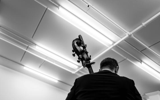 Double Bass being played black and white