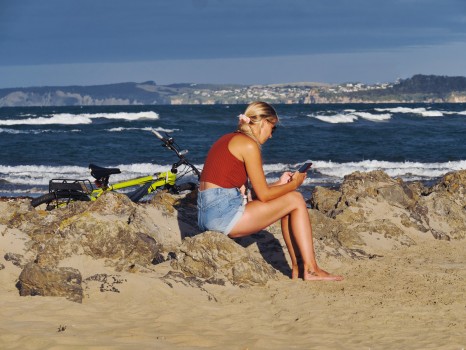 Girl with bicycle at the beach