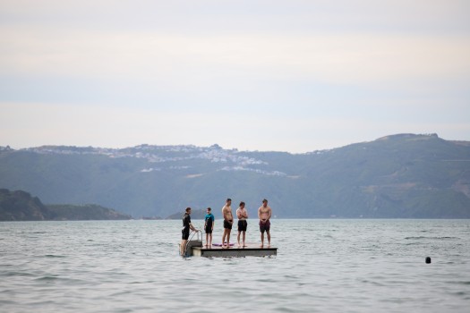 Boys on a floating platform in the water
