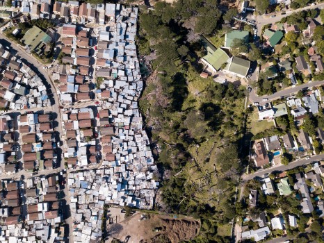 Aerial over township and wealthy houses