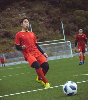V-Well player in red kit and lime green cleats - Sports Zone sunday league