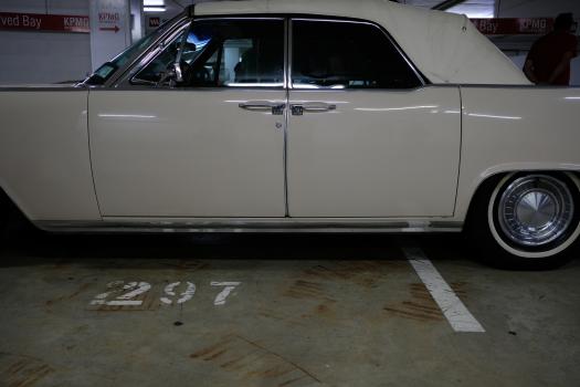 Classic white Lincoln Continental with soft top and suicide doors