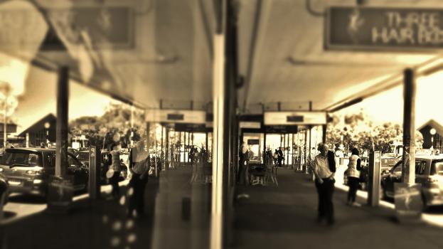 Reflection of the street on Ponsonby shopping strip sepia