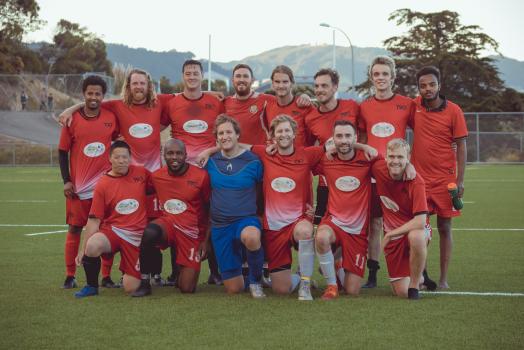 Group photo of team in red kit - Sports Zone sunday league