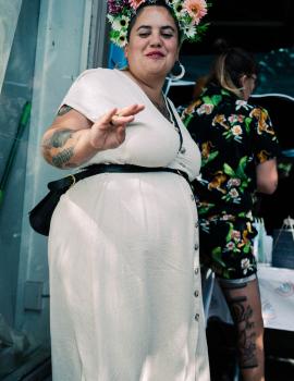 Tattooed women wearing flowers in hair at Newtown Festival 2020