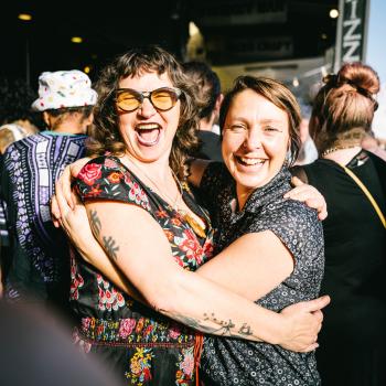 Two women hugging and smiling at Newtown festival 2021