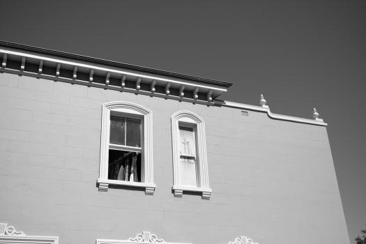 A building with small and large window black and white