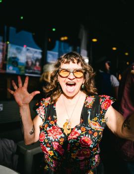 Tattooed woman cheering at Newtown festival 2021
