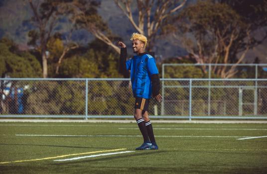 Player with blonde hair waving hand - Sports Zone sunday league