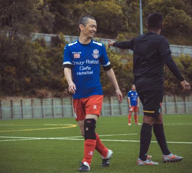 Asian player exchange a smile with opponent - Sports Zone sunday league