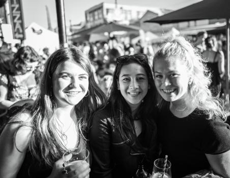 A trio of female friends posing for a picture at Newtown festival 2021 black and white
