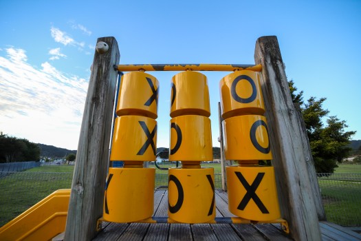 Tic tac toe on revolving yellow drums