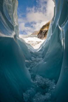 Walking through an ice cave on the glacier
